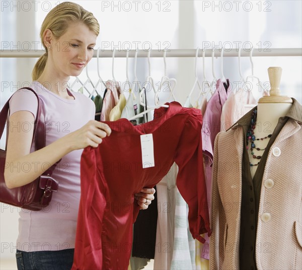 Woman looking at clothing in store.