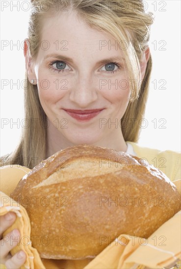 Woman holding loaf of bread.