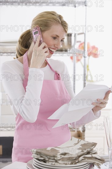 Female caterer talking on cell phone.