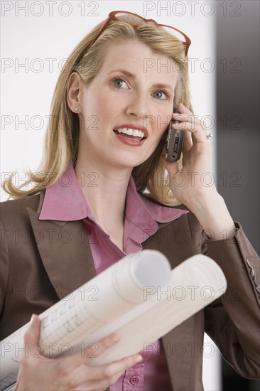 Female architect talking on cell phone.