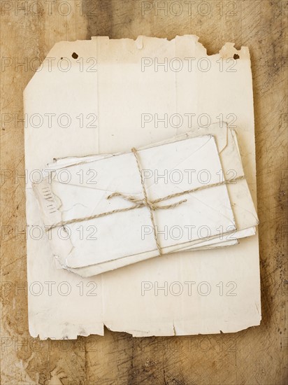 Stack of old letters on piece of paper.