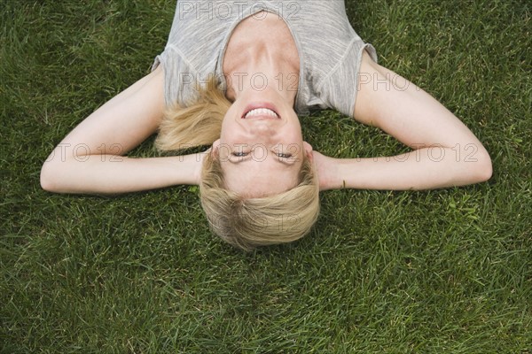 Woman laying in grass.