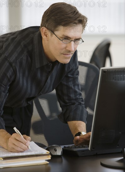 Businessman looking at computer.