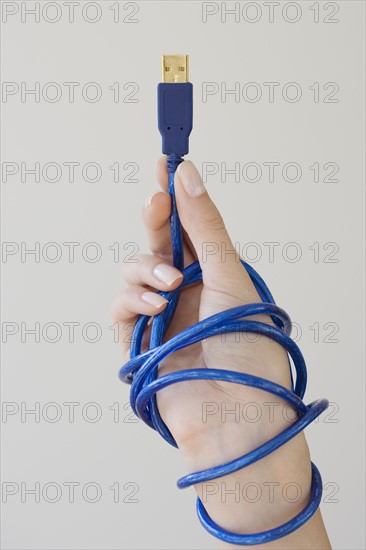 Woman holding USB cable.