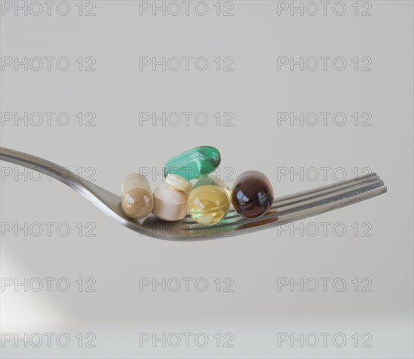 Close up of pills on fork.
