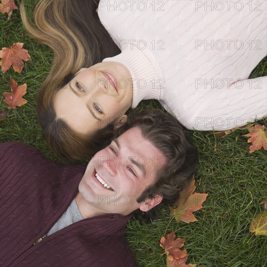 Couple laying in grass.