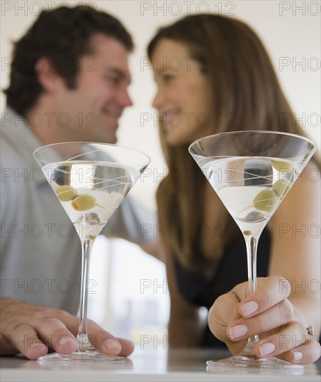 Couple drinking martinis.