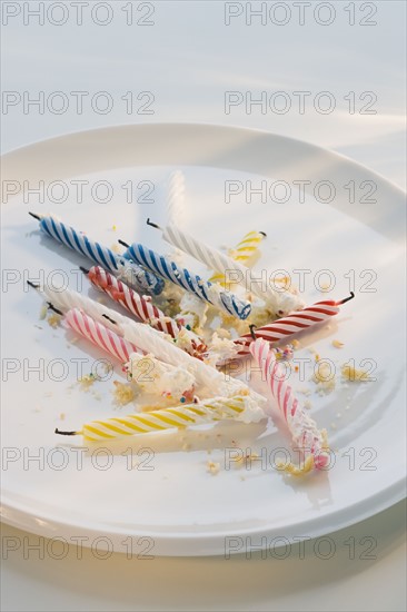 Birthday candles and crumbs on plate.