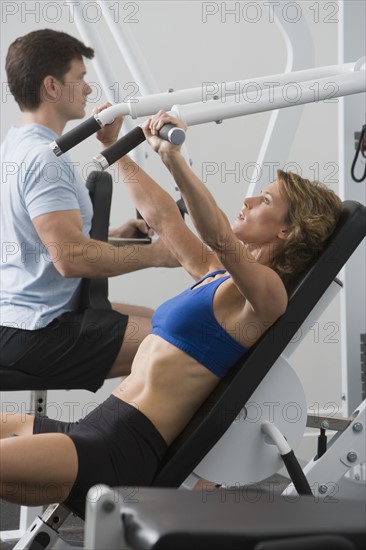 Couple exercising at gym.