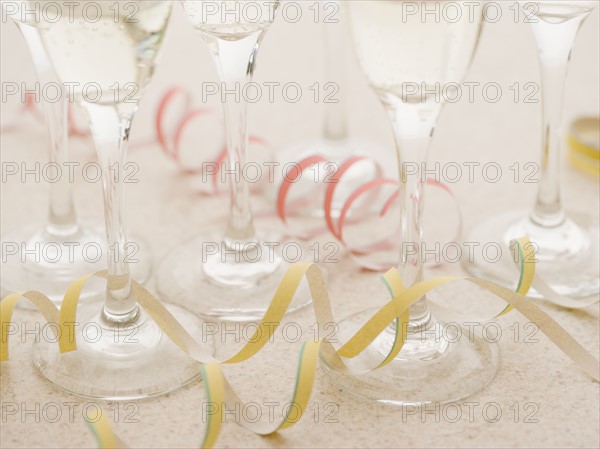 Curls of confetti with wineglasses. Date : 2006