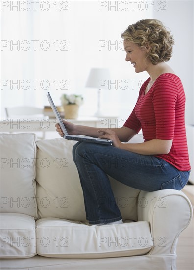 Woman looking at laptop.