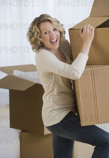 Woman carrying moving boxes.