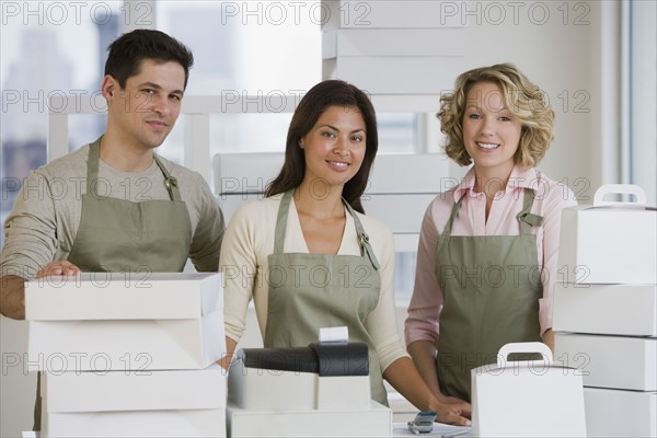 Multi-ethnic bakery workers behind counter.