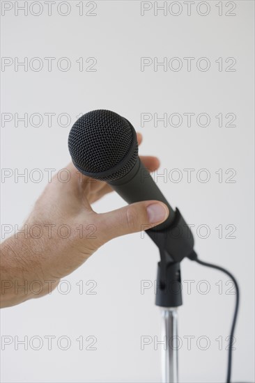 Man reaching for microphone.