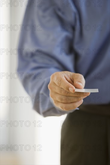 Businessman handing out business card.