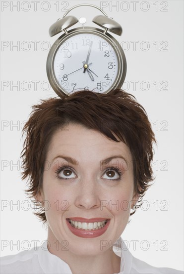 Woman with alarm clock on head.