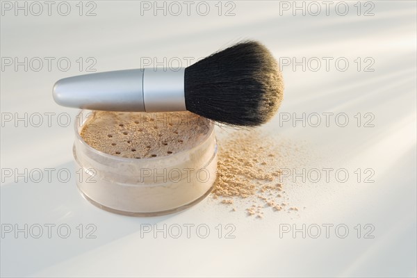 Powdered mineral makeup and brush .