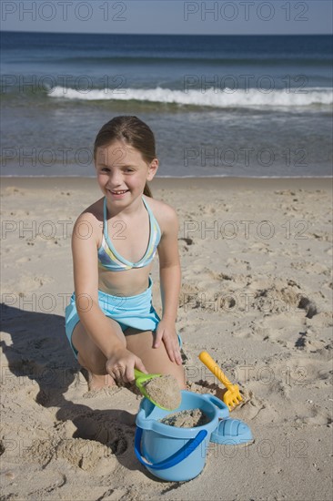 Girl playing in sand.