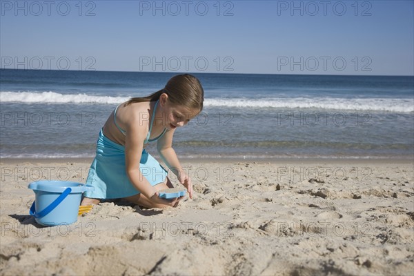 Girl playing in sand.
