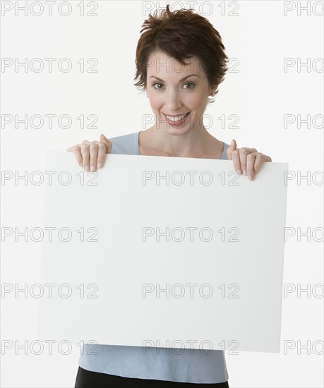 Businesswoman holding blank sign.
