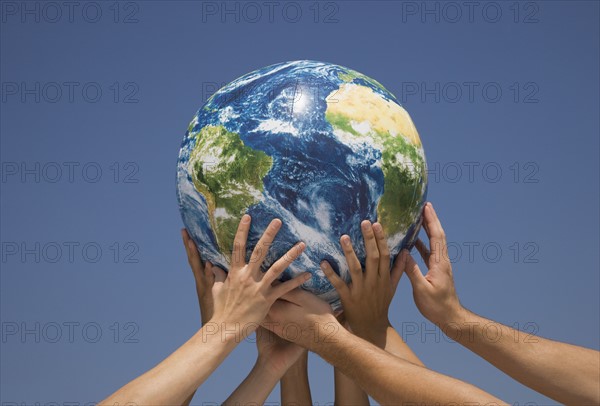 Hands holding up globe.