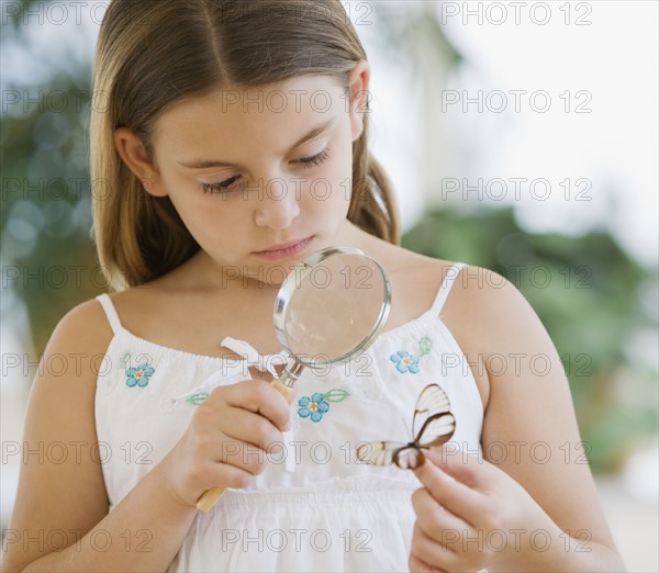 Girl examining butterfly.
