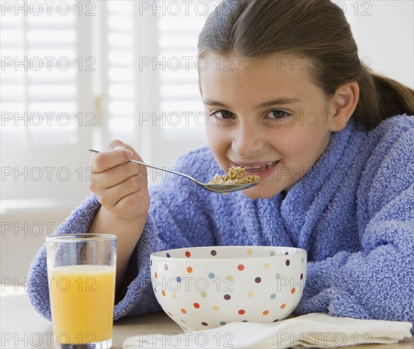 Girl eating breakfast cereal.