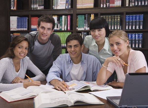 College students studying in library.