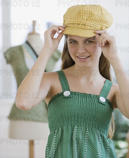 Girl trying on hat.