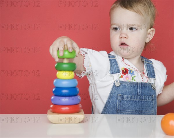 Female toddler playing with rings. Date : 2006