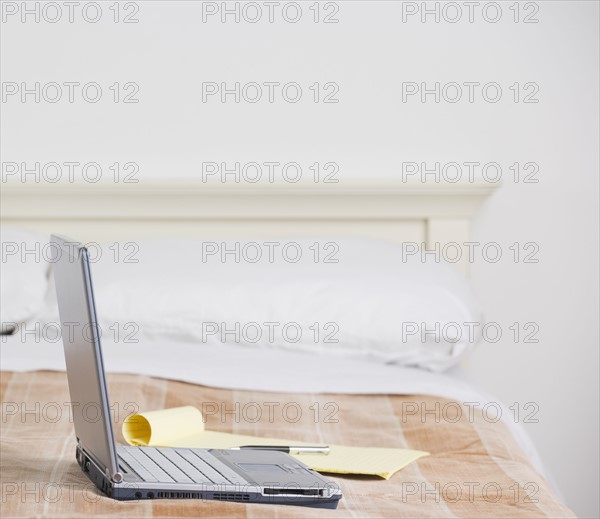 Still life of laptop computer on bed. Date : 2006