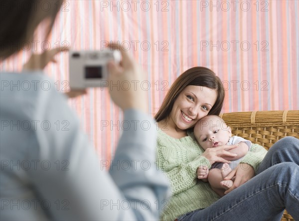 Mother and baby having their photograph taken. Date : 2006