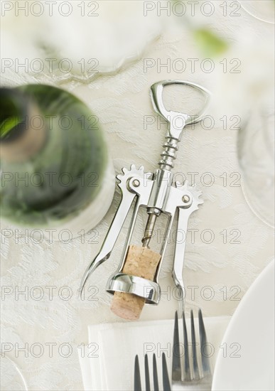 Table setting with wine and corkscrew. Date : 2006