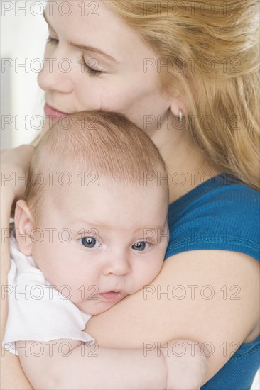 Mother hugging baby. Date : 2006