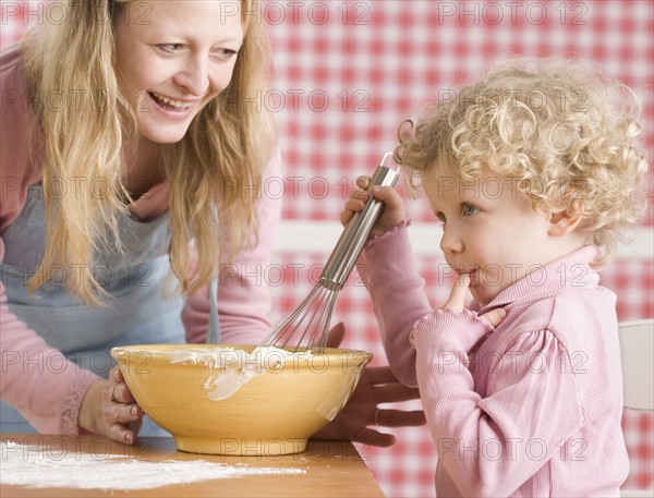 Mother and child cooking. Date : 2006