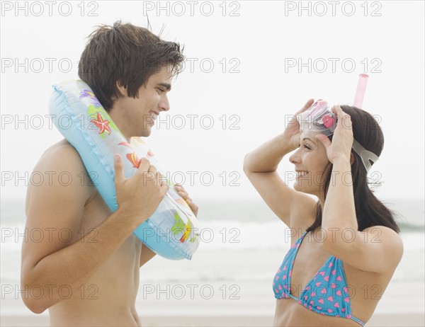 Couple smiling at each other at beach. Date : 2006