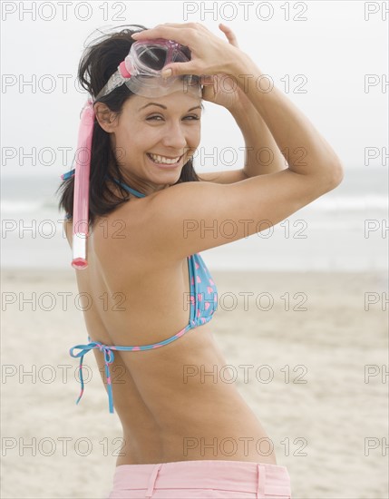 Woman smiling at beach with snorkel mask. Date : 2006