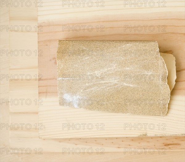 Close up of sandpaper on wood. Date : 2006