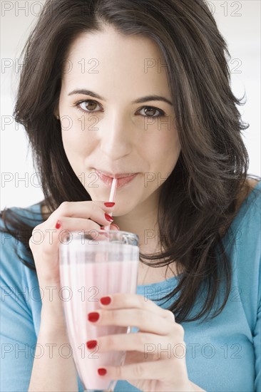 Woman drinking milkshake with straw. Date : 2007