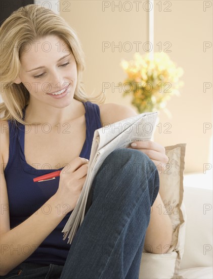 Woman looking at newspaper . Date : 2007