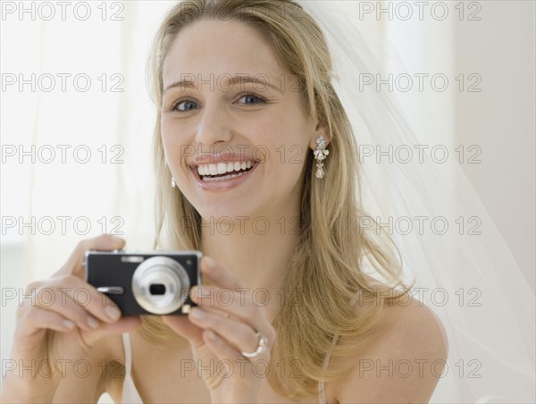 Bride taking photograph. Date : 2007