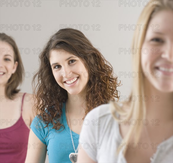 Portrait of teenage girl next to friends. Date : 2007