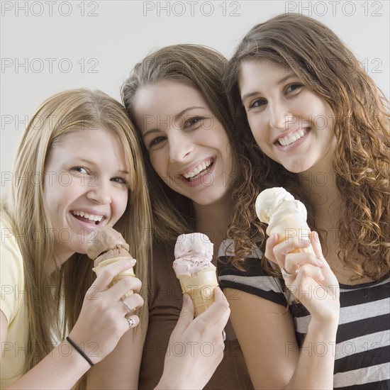 Portrait of teenage girls eating ice cream cones. Date : 2007