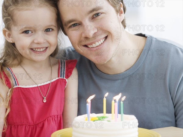 Father and daughter with birthday cake. Date : 2007