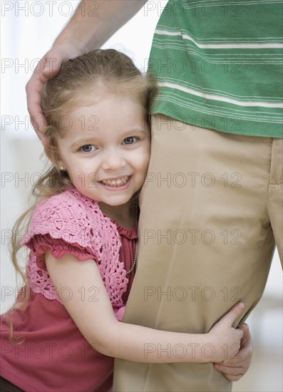 Girl hugging father’s leg. Date : 2007