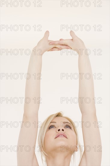 Woman stretching hands over head. Date : 2007