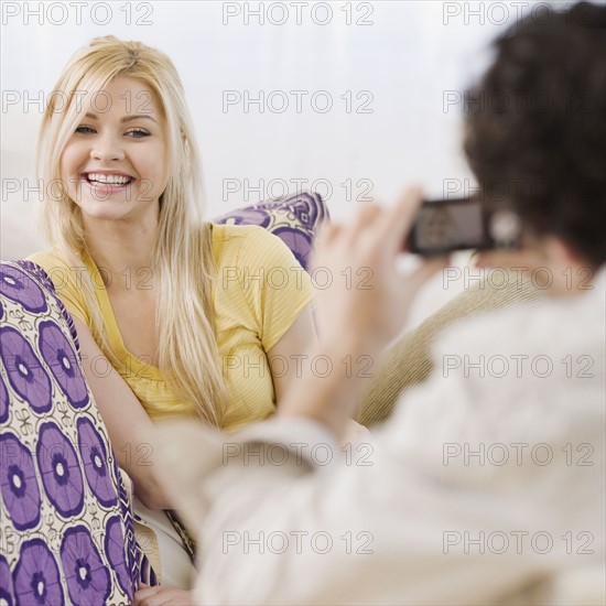 Man taking photograph of girlfriend. Date : 2007