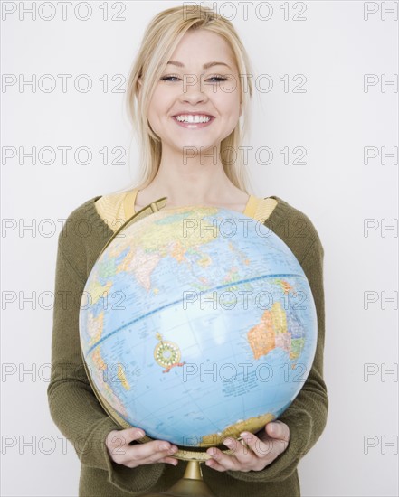 Woman holding globe. Date : 2007