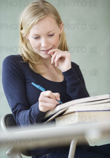 Woman writing in notebook. Date : 2007