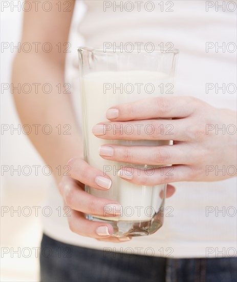 Woman holding glass of milk. Date : 2007
